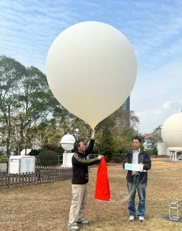 天文台工作人員施放攜帶低溫霜點濕度計的探空氣球，以精確測量高空水氣含量。